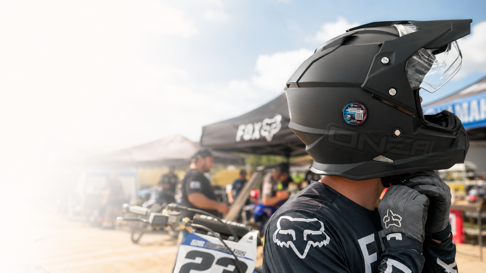 Motocross rider wearing a helmet fitted with a RiderSOS Emergency Helmet Tag