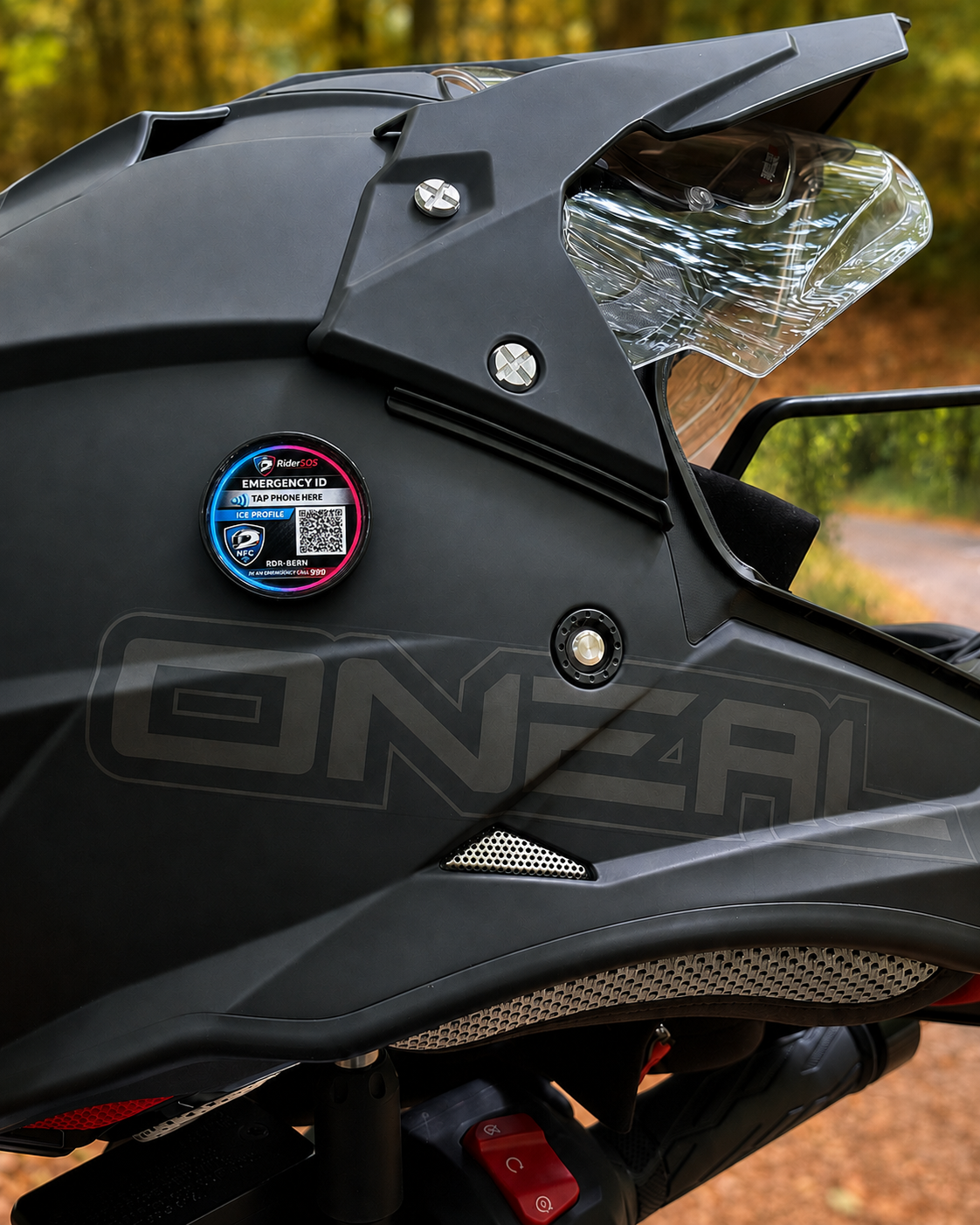 Motorcyclist wearing an adventure helmet fitted with a RiderSOS helmet tag