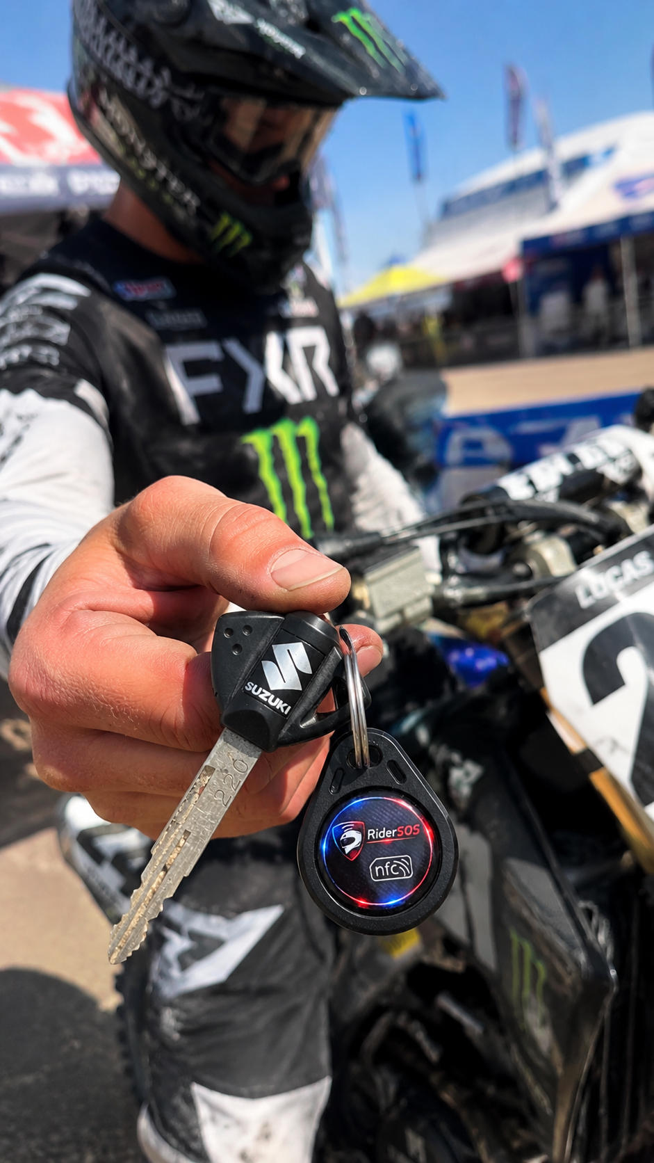 Rider holding a RiderSOS emergency ID key tag